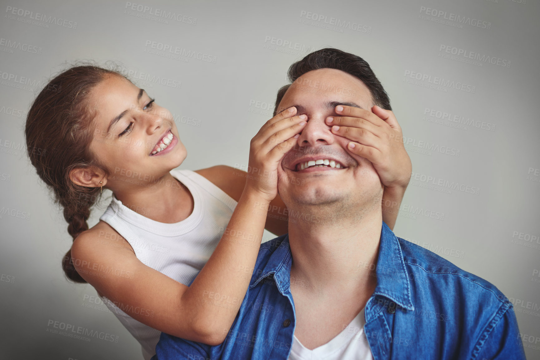 Buy stock photo Peekaboo, child and man in studio for surprise, game and bonding with love. Family, father and young girl cover eyes on gray background with trust, guess who or secret with happiness for relationship