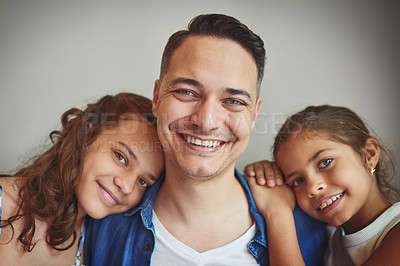 Buy stock photo Happy, man and girls with portrait in studio for fathers day, bonding together and embrace of support. Smile, parent and children with hug for family, relationship and childhood on gray background