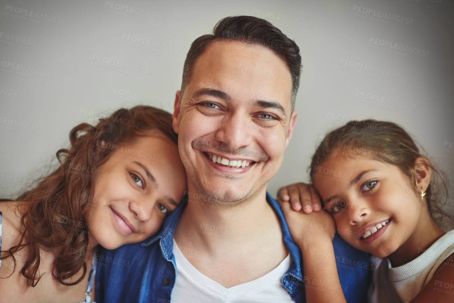 Buy stock photo Happy, man and girls with portrait in studio for fathers day, bonding together and embrace of support. Smile, parent and children with hug for family, relationship and childhood on gray background