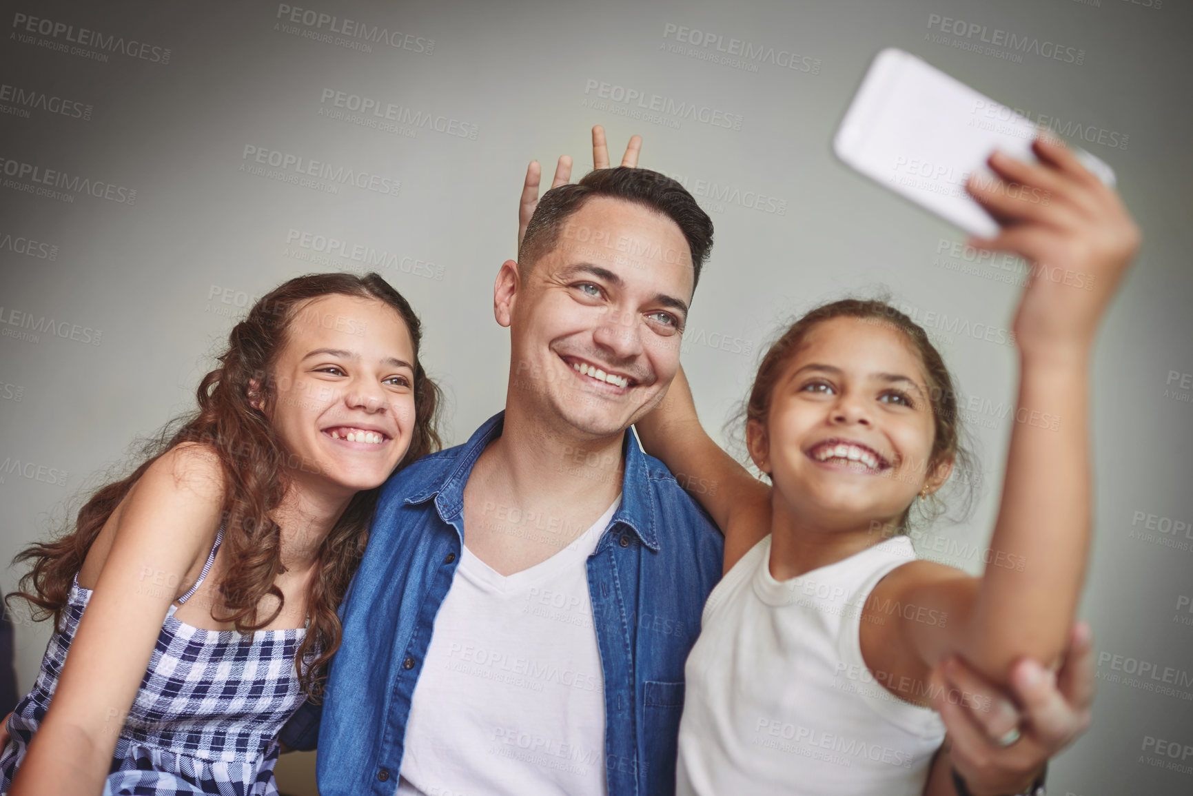 Buy stock photo Smile, father and children with selfie at house for photography, bonding together and social media post. Goofy, man and kids with embrace of profile picture update, family safety and childhood memory