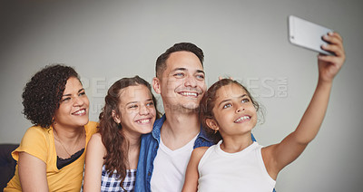 Buy stock photo Cropped shot of a happy family of four taking a selfie together