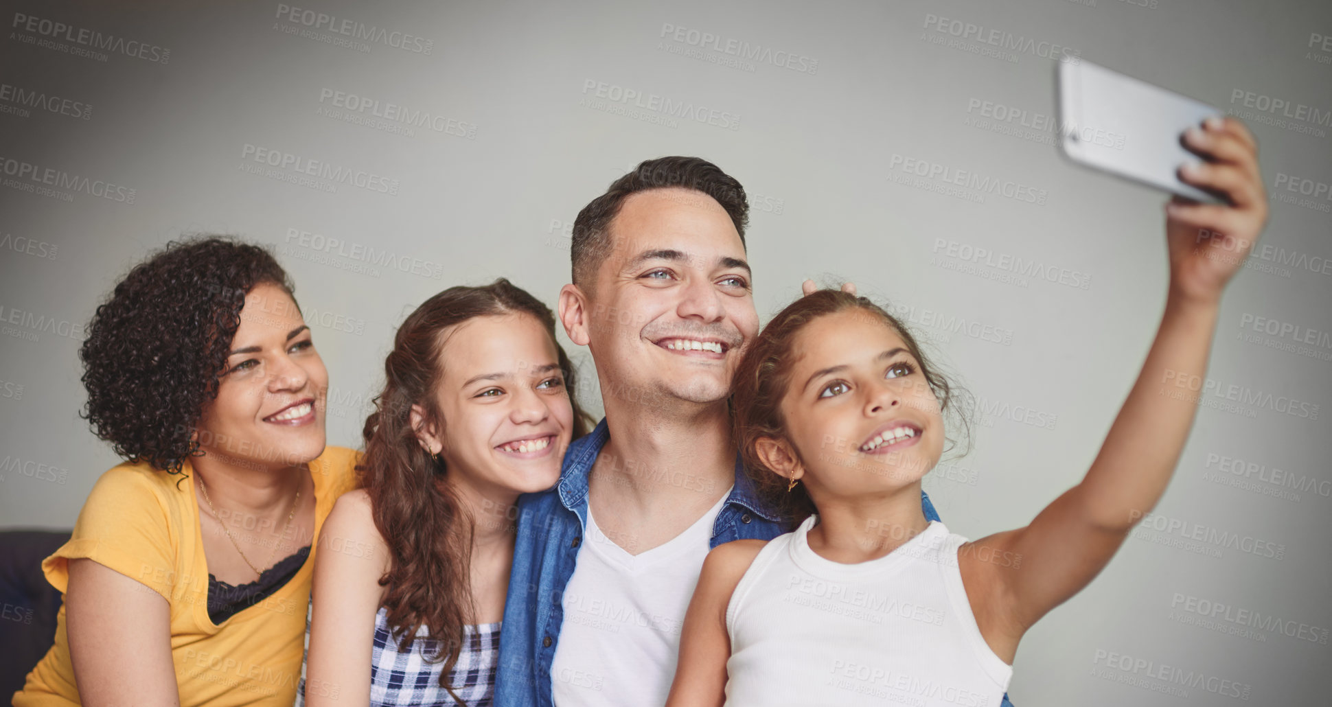 Buy stock photo Cropped shot of a happy family of four taking a selfie together