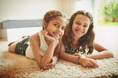 Buy stock photo Shot of two young girls spending time together at home