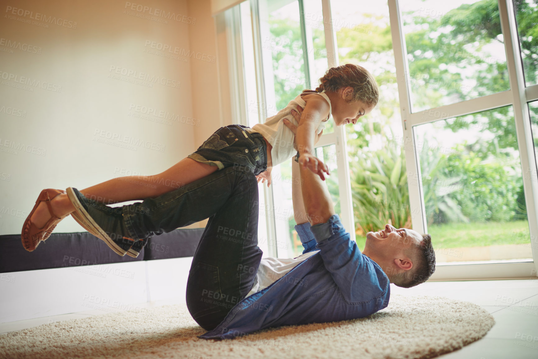 Buy stock photo Dad, airplane and girl on floor, playful and lift for games, relax and bonding with love in family home. Father, child and care with plane, fantasy and together on living room carpet at apartment