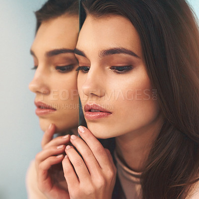 Buy stock photo Shot of a beautiful young woman leaning against a mirror