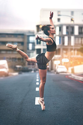 Buy stock photo Shot of a beautiful young woman doing ballet outdoors in the city