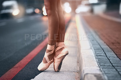 Buy stock photo Cropped shot of a ballet dancer standing on tiptoes against an urban background