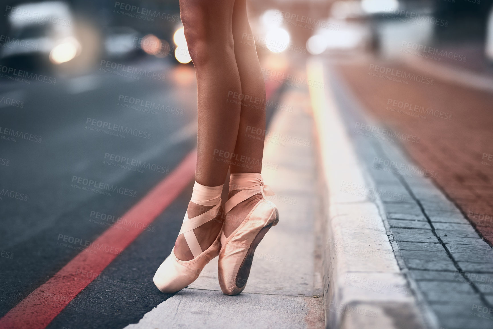 Buy stock photo Cropped shot of a ballet dancer standing on tiptoes against an urban background