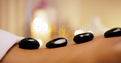 Buy stock photo Shot of an unrecognizable woman getting a hot stone massage at a beauty spa