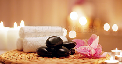 Buy stock photo Candles, towels and hot stones at a spa for a massage, healing or luxury treatment therapy. Health, aromatherapy and wellness body care products for a calm, zen or peace atmosphere at a natural salon