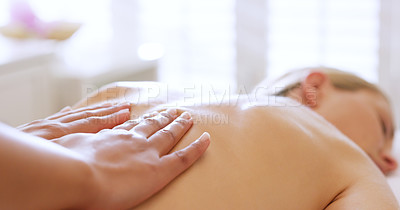 Buy stock photo Shot of a beautiful young woman enjoying a back massage at a beauty spa