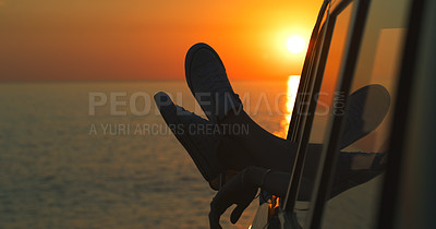 Buy stock photo Cropped shot of an unrecognizable woman's legs dangling out the window of a car at the beach