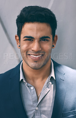 Buy stock photo Closeup portrait of a handsome young businessman standing against a grey wall