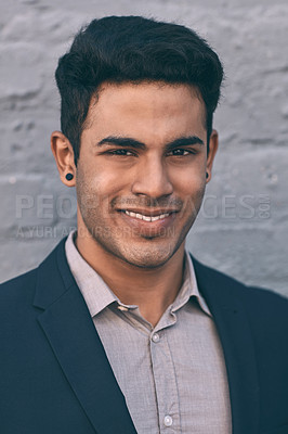 Buy stock photo Closeup portrait of a handsome young businessman standing against a grey face brick wall