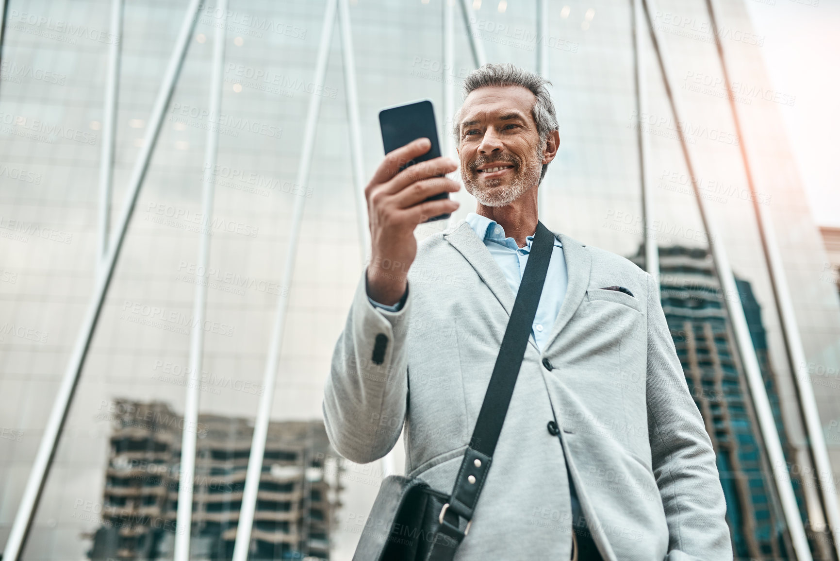 Buy stock photo Corporate, man and scroll with phone in city of morning commute, communication and transport service. Low angle, mature lawyer and mobile app with taxi request, meeting schedule and travel location