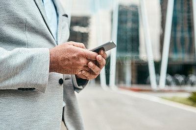 Buy stock photo Closeup shot of an unrecognizable businessman using a cellphone outdoors