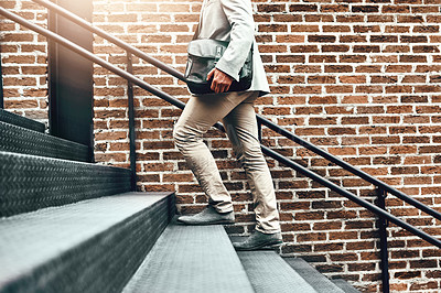 Buy stock photo Closeup shot of an unrecognizable businessman walking up a staircase while out in the city