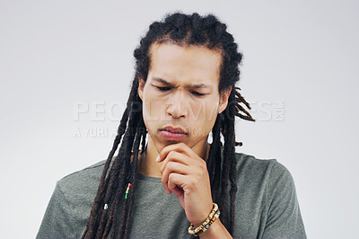Buy stock photo Studio shot of a young person looking thoughtful against a gray background