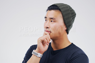 Buy stock photo Studio shot of a man looking thoughtful against a gray background