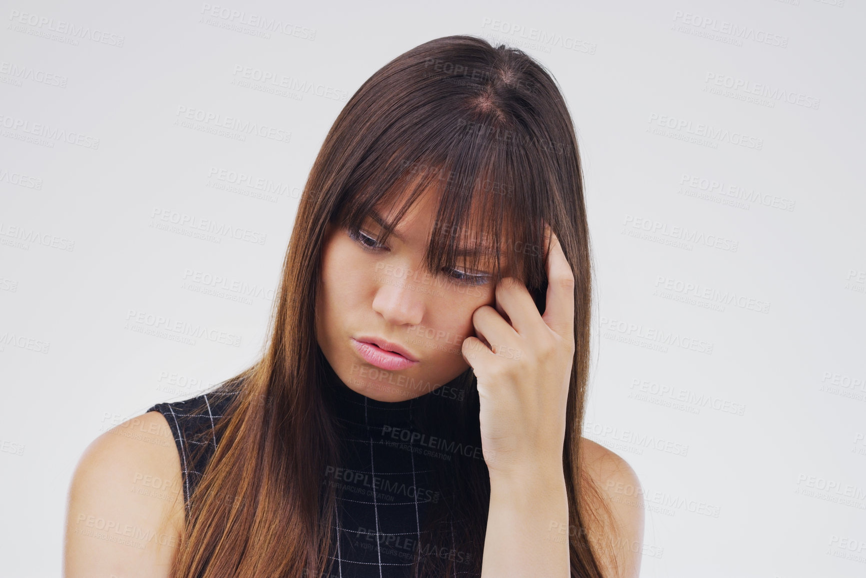 Buy stock photo Studio shot of a young woman looking thoughtful against a gray background