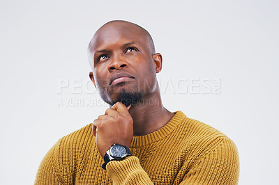 Buy stock photo Studio shot of a man looking thoughtful against a gray background