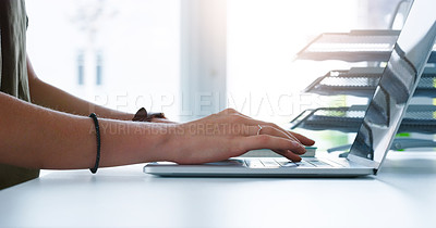Buy stock photo Cropped shot of an unrecognizable businesswoman typing on her laptop inside of the office at work