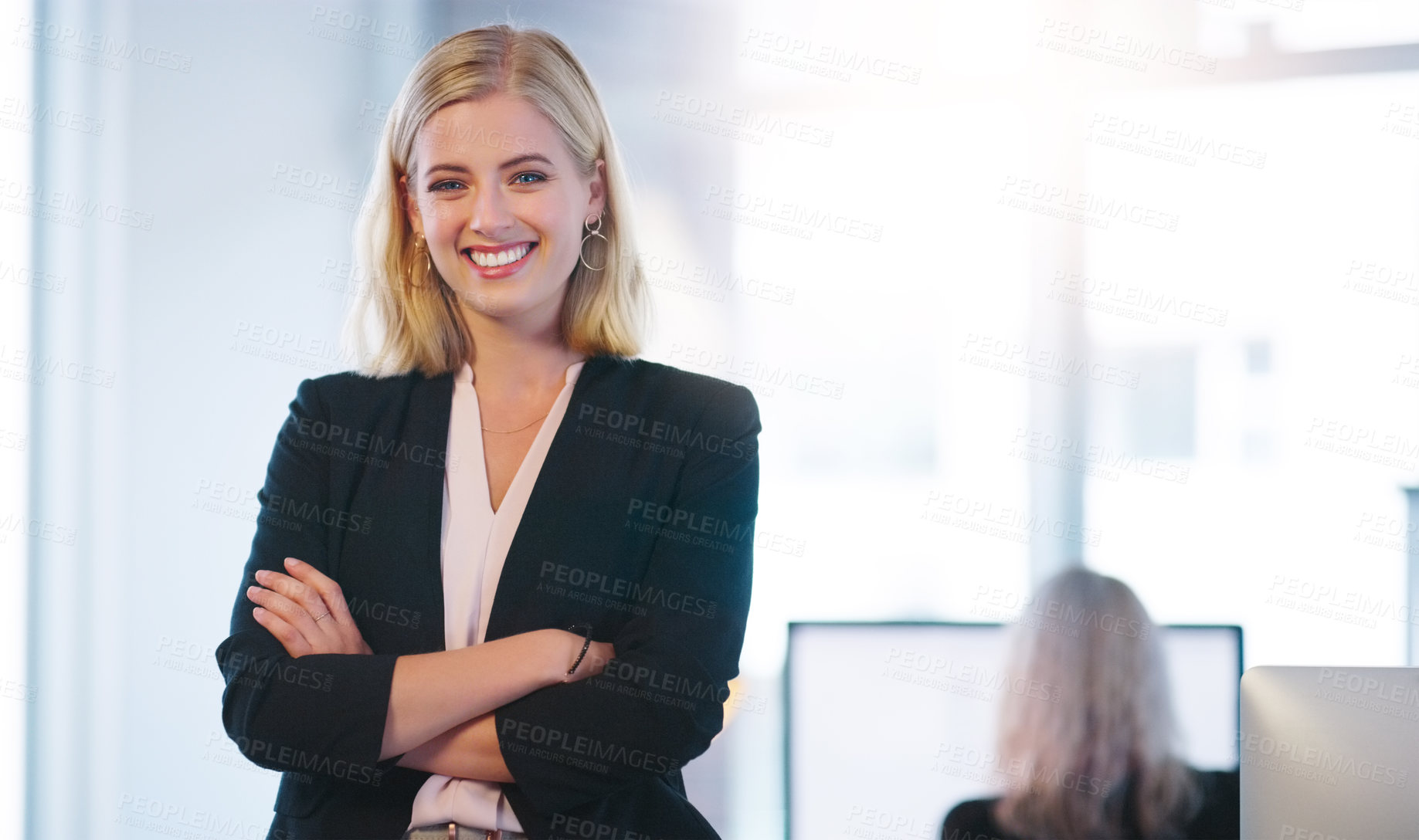 Buy stock photo Portrait of a confident young businesswoman standing with her arms folded inside of the office