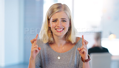 Buy stock photo Portrait of a confident young businesswoman crossing her fingers inside of the office at work