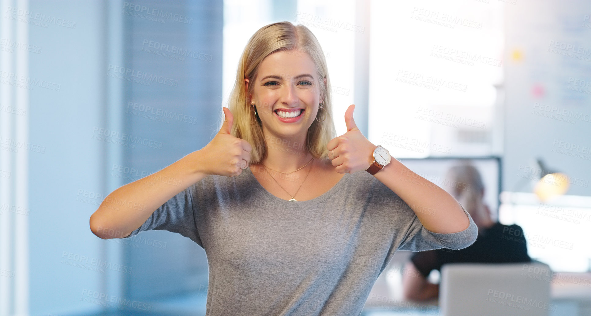 Buy stock photo Portrait of a confident young businesswoman showing thumbs up while standing inside of the office at work