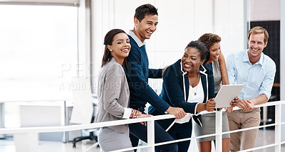 Buy stock photo Cropped shot of a happy group of colleagues sharing a laugh together in the office