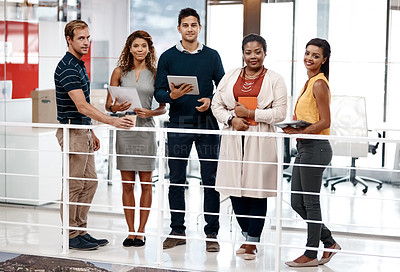 Buy stock photo Full length shot of a diverse group of colleagues standing together in the office and smiling at the camera