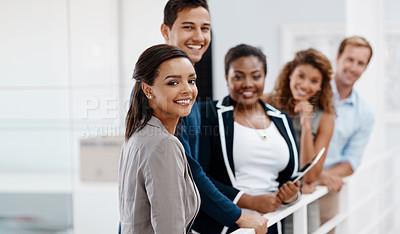 Buy stock photo Cropped shot of a diverse group of colleagues standing together in the office and smiling at the camera