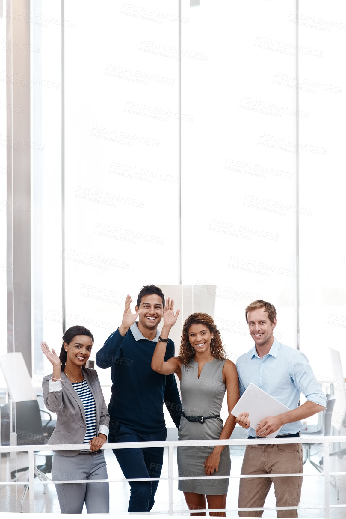Buy stock photo Shot of a diverse group of colleagues waving at the camera with their arm raised at the office