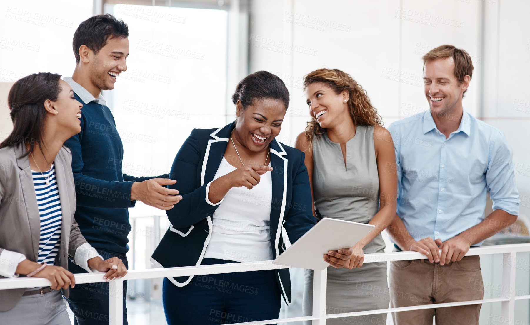 Buy stock photo Shot of a happy group of colleagues sharing a laugh together in the office