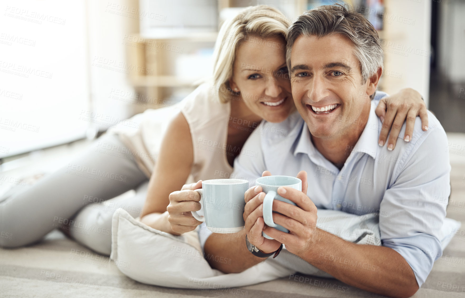 Buy stock photo Home, mature couple and portrait with hug for coffee, warm beverage and bonding together on carpet. House, man and woman with love embrace for relax, commitment and healthy marriage with happiness