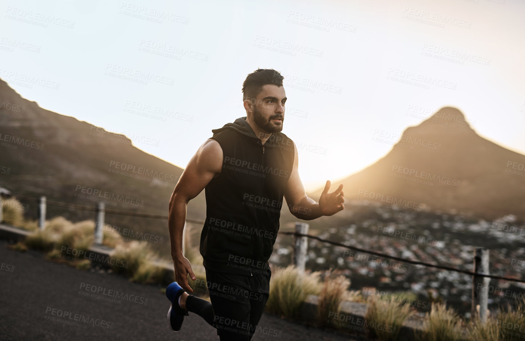 Buy stock photo Shot of a sporty young man exercising outdoors