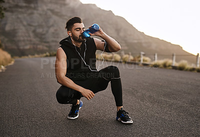 Buy stock photo Drinking water, music and outdoor for fitness, man and athlete with earphones, break and hydration. Healthy, runner and person with liquid for wellness, workout and electrolytes  for thirst.