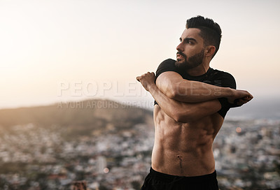 Buy stock photo Shot of a sporty young man lifting up his top while exercising outdoors