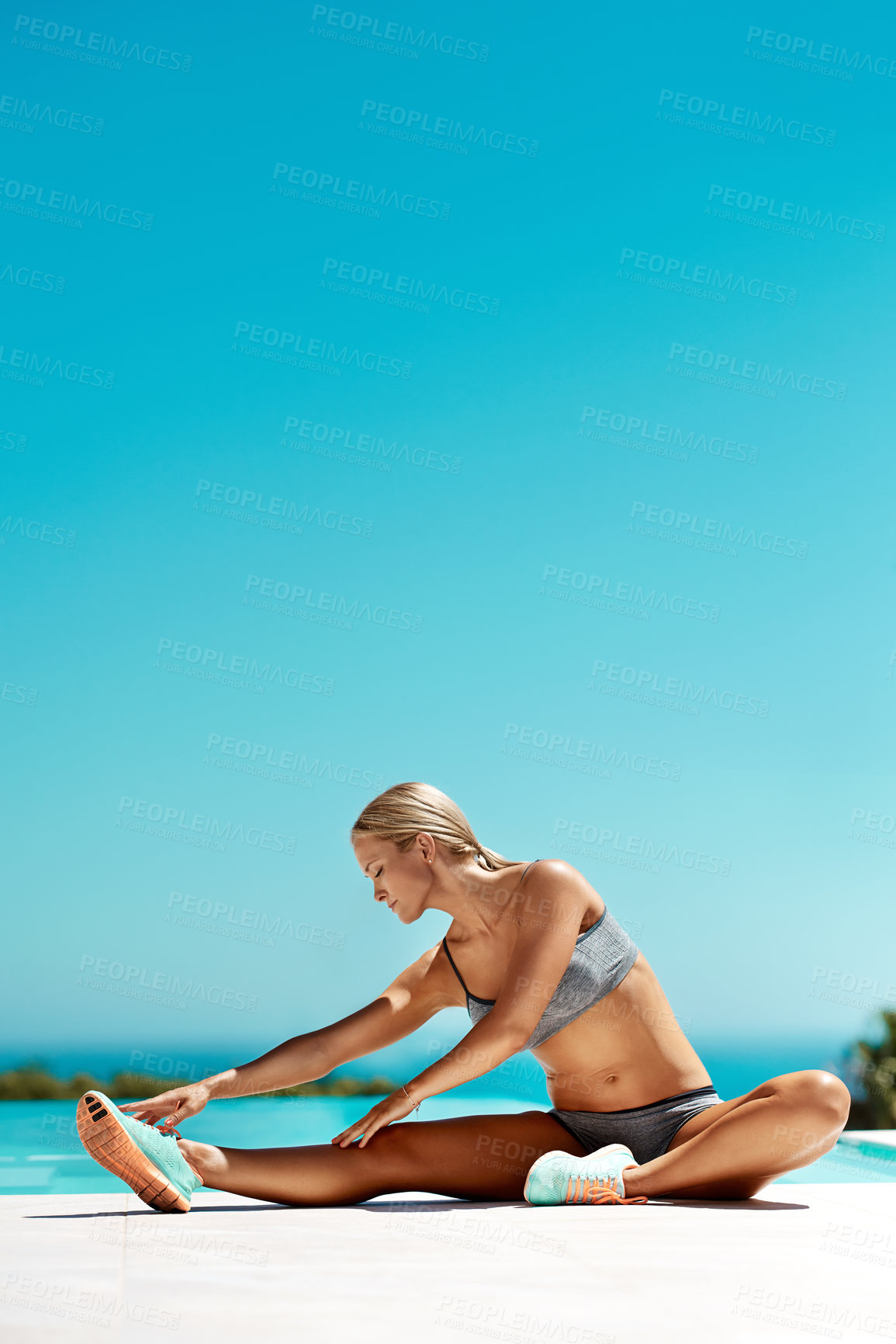 Buy stock photo Woman, workout and stretching legs for exercise, fitness and sports activity outdoor with blue sky on patio. Athlete, training and mockup space for health, flexibility and strength by swimming pool