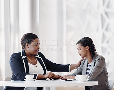 Buy stock photo Cropped shot of an attractive young businesswoman being consoled by a female colleague in their workplace