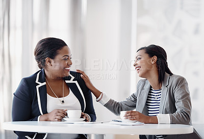 Buy stock photo Cropped shot of two attractive young businesswomen having a laugh while working together in their office