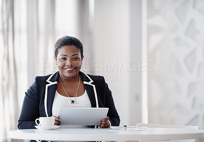 Buy stock photo Cropped portrait of an attractive young businesswoman using her tablet while working in the office