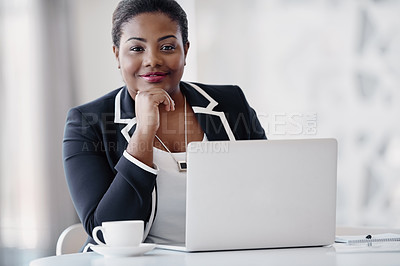Buy stock photo Cropped portrait of an attractive young woman looking thoughtful while working on her laptop in the office