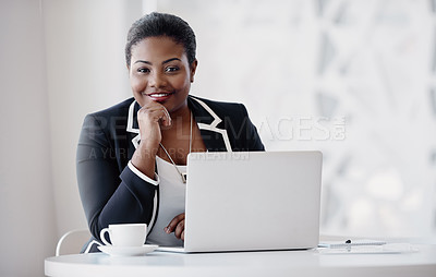 Buy stock photo Cropped portrait of an attractive young woman looking thoughtful while working on her laptop in the office
