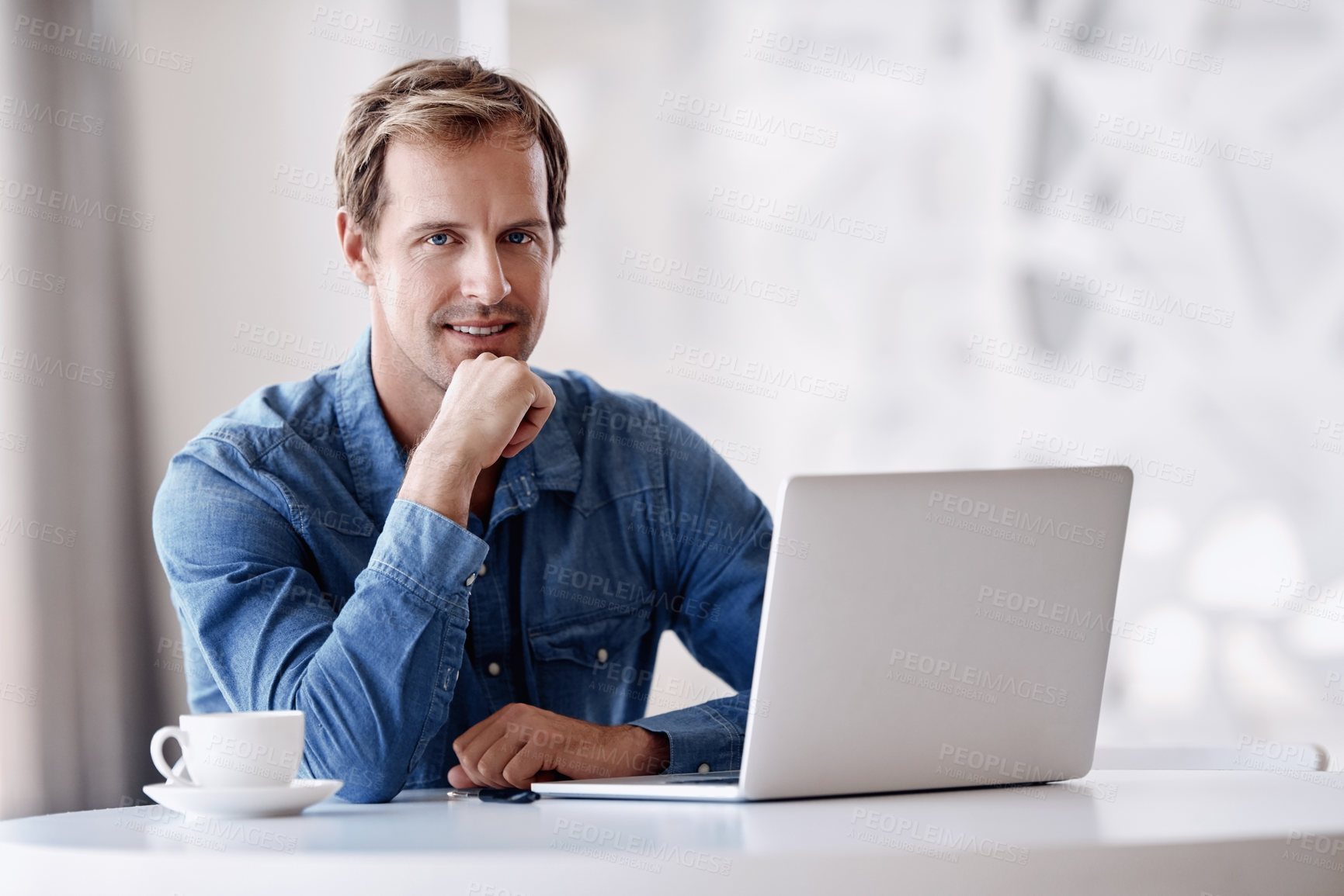 Buy stock photo Cropped portrait of a handsome mature businessman looking thoughtful while working on his laptop in the office