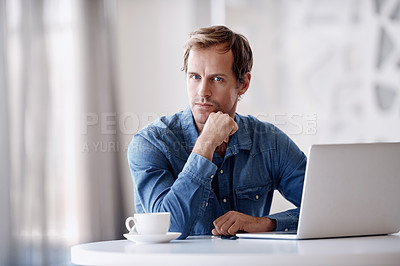 Buy stock photo Cropped portrait of a handsome mature businessman looking thoughtful while working on his laptop in the office