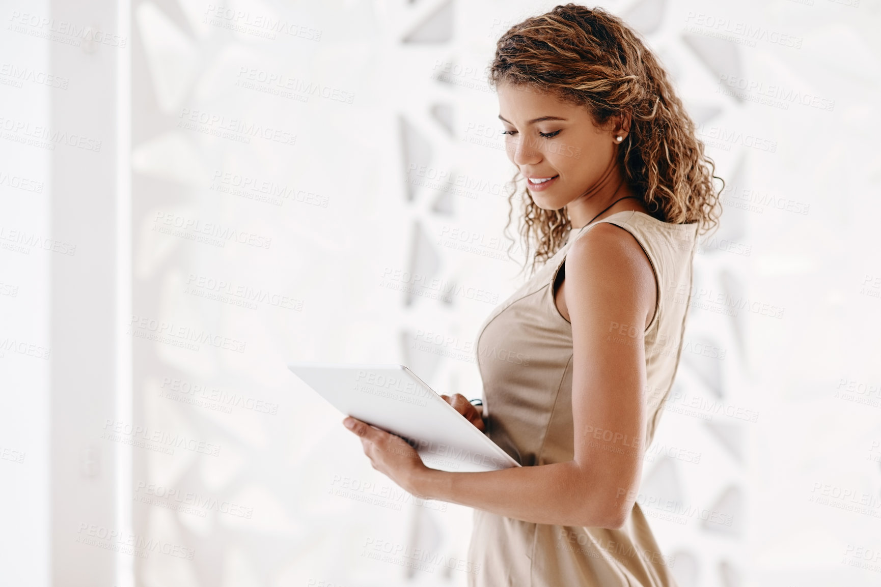 Buy stock photo Cropped shot of an attractive young businesswoman using her laptop while standing in the office