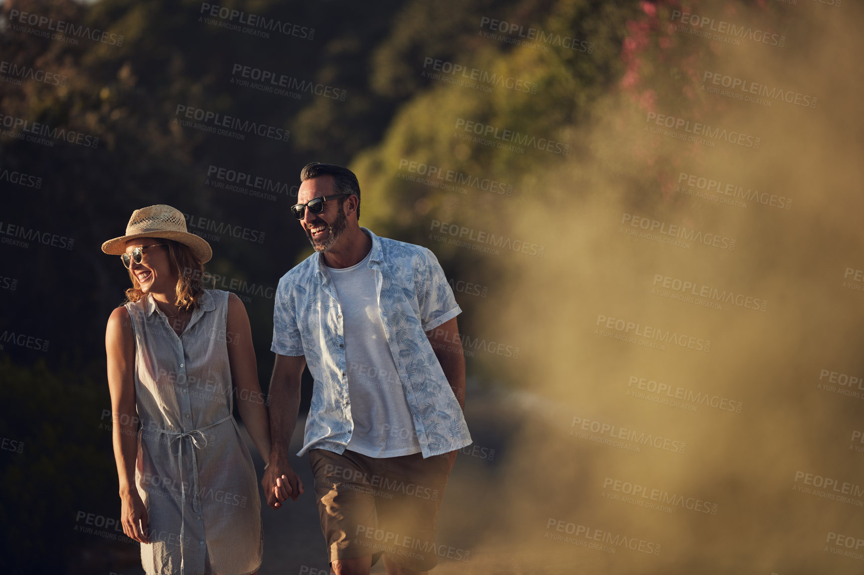 Buy stock photo Shot of an affectionate mature couple taking a walk outdoors