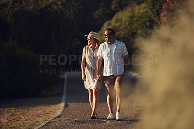 Buy stock photo Shot of an affectionate mature couple taking a walk outdoors