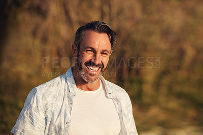 Buy stock photo Shot of a handsome mature man spending time in the great outdoors